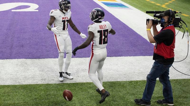 Falcons wide receiver Calvin Ridley (18) celebrates with Julio Jones after catching an 8-yard touchdown pass during the first half against the Minnesota Vikings, Sunday, Oct. 18, 2020, in Minneapolis. (Bruce Kluckhohn/AP)