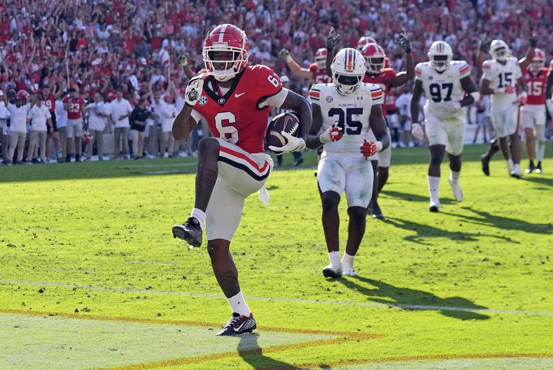 Georgia wide receiver Dominic Lovett (6) runs in for a touchdown after catching a pass in the first half of an NCAA college football game against Auburn Saturday, Oct. 5, 2024, in Athens, Ga. (AP Photo/John Bazemore)