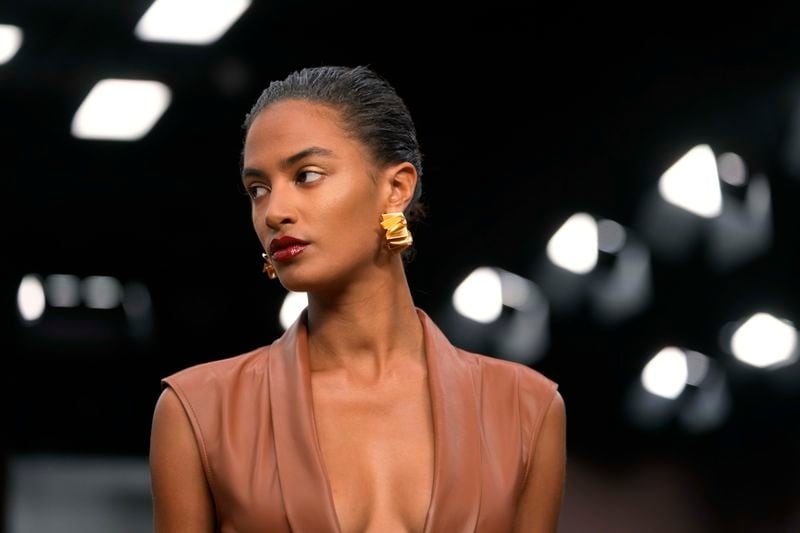 A model wears a creation as part of the Ferrari Spring Summer 2025 collection, that was presented in Milan, Italy, Saturday, Sept. 21, 2024. (AP Photo/Luca Bruno).