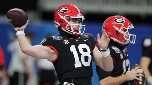 Georgia quarterback JT Daniels (left) and Stetson Bennett (right) prepare to play Cincinnati in the Chick-fil-A Peach Bowl Friday, Jan. 1, 2021, at Mercedes-Benz Stadium in Atlanta. (Curtis Compton / Curtis.Compton@ajc.com)