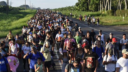 Migrants walk along the highway through Suchiate, Chiapas state in southern Mexico, Sunday, July 21, 2024, during their journey north toward the U.S. border. (AP Photo/Edgar H. Clemente)