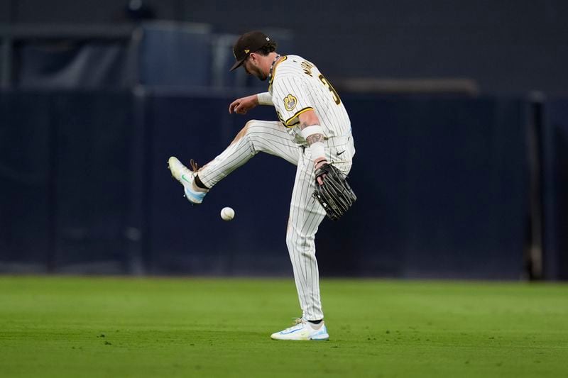 San Diego Padres centerfielder Jackson Merrill juggles the ball at the start of the sixth inning in Game 2 of an NL Wild Card Series baseball game against the Atlanta Braves Wednesday, Oct. 2, 2024, in San Diego. (AP Photo/Gregory Bull)