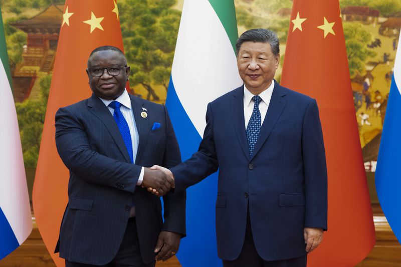 In this photo released by Xinhua News Agency, Chinese President Xi Jinping, right, shakes hands with Sierra Leone President Julius Maada Bio before their bilateral meeting at the Great Hall of the People in Beijing, Wednesday, Sept. 4, 2024, ahead of the China Africa Forum. (Huang Jingwen/Xinhua via AP)