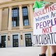 A protester held a sign outside the Nathan Deal Justice Center during the hearing of the challenge to Georgia's abortion law at the Georgia Supreme Court on Tuesday, March 28, 2023.
 Miguel Martinez / miguel.martinezjimenez@ajc.com