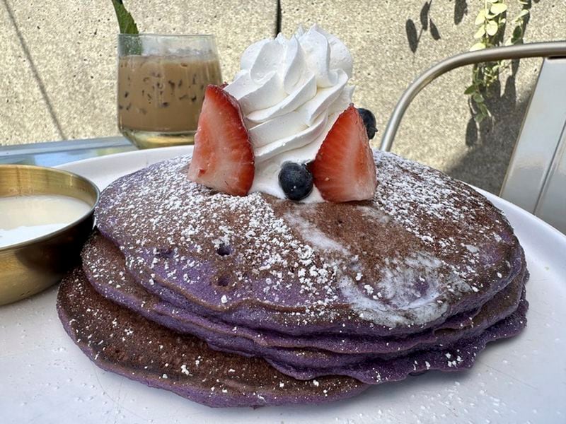 An order of "Ooh BAE Pancakes," ube pancakes with sea salt crema and coconut syrup, is served at Breaking Dawn restaurant in Los Gatos, Calif., on Sunday, Aug. 4, 2024. (AP Photo/Terry Tang)