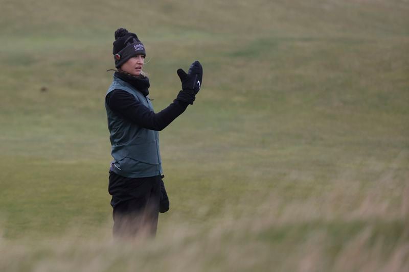 Nelly Korda, of the United States, looks towards the pin as she prepares to play her second shot on the 13th hole during the final round of the Women's British Open golf championship, in St. Andrews, Scotland, Sunday, Aug. 25, 2024. (AP Photo/Scott Heppell)