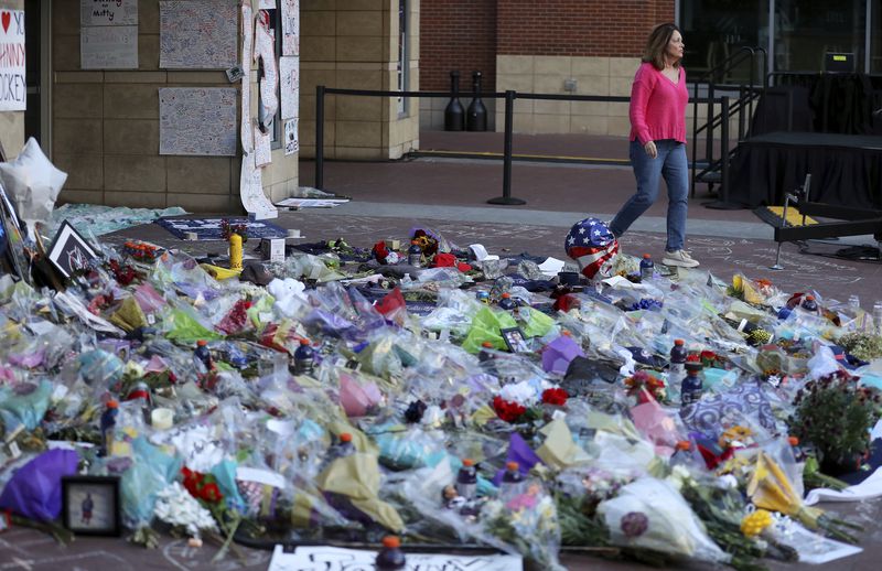 Fans leave flowers and mementos as part of the candlelight vigil to honor Columbus Blue Jackets hockey player Johnny Gaudreau, Thursday, Sept. 4, 2024, outside of Nationwide Arena in Columbus, Ohio. Gaudreau and his brother Matthew were killed by a motor vehicle last week while riding bicycles. (AP Photo/Joe Maiorana)