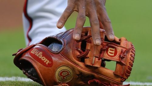 Atlanta Braves second baseman Ozzie Albies grabs his glove.