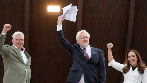 Wikileaks founder Julian Assange, center, his wife Stella Assange, right, and editor-in-chief of WikiLeaks Kristinn Hrafnsson, raise their fists as they arrive at the Council of Europe, in Strasbourg, eastern France, Tuesday, Oct. 1, 2024. (AP Photo/Pascal Bastien)