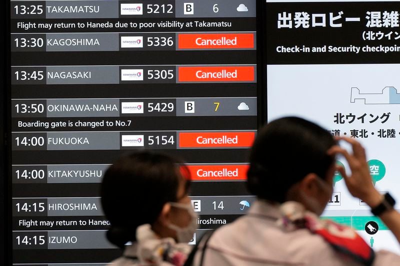 A departing flight information board shows that some flights were canceled due to an approaching Typhoon Shanshan at Haneda airport Thursday, Aug. 29, 2024, in Tokyo. (AP Photo/Eugene Hoshiko)