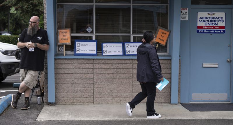 Sergeant at Arms John Olson, left, stands by to direct International Aerospace Machinists voting on a contract offer with airplane maker, Boeing at the union's hall, on Thursday, Sept. 12, 2024, in Renton, Wash. (AP Photo/Stephen Brashear)