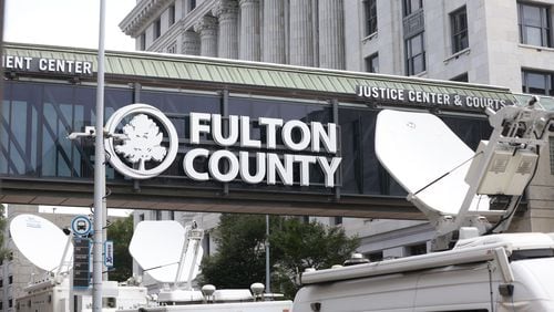 Media satellite trucks park outside of Fulton County Courthouse on Tuesday, August 15, 2023. Fulton District Attorney Fani Willis indicted former President Donald Trump along with 18 other defendants Monday night on charges related attempts to overturn s 2020 presidential election results. (Natrice Miller/ natrice.miller@ajc.com)