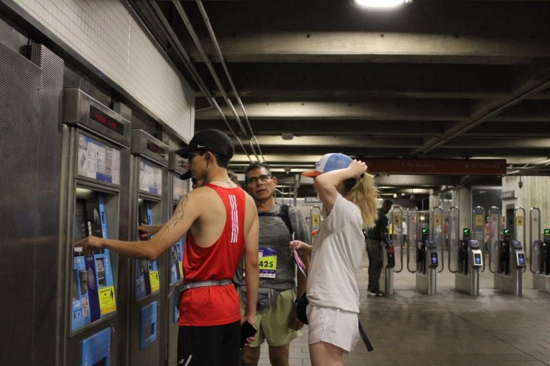 Atlanta Journal-Constitution Peachtree Road Race runners prepare to take the Arts Center MARTA train to the starting line early Thursday morning, July 4, 2024. (Photo: Sarah Coyne/AJC)