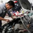 Auto mechanic Willie Chung works on a vehicle at the Express Auto Service Inc., in Chicago, Thursday, Sept. 19, 2024. (AP Photo/Nam Y. Huh)