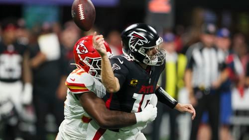 Atlanta Falcons quarterback Kirk Cousins is hit by Kansas City Chiefs defensive end Felix Anudike-Uzomah and Cousins fumbles the ball during the second quarter at Mercedes-Benz Stadium, Sunday, Sept. 22, 2024, in Atlanta. The ball rolled out of bounds and Atlanta kept possession of the ball. (Jason Getz / AJC)

