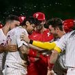 Philadelphia Phillies' Nick Castellanos, center left, celebrates with teammates after hitting a walk off single against Atlanta Braves' Grant Holmes during the 11th inning of a baseball game, Sunday, Sept. 1, 2024, in Philadelphia. (AP Photo/Derik Hamilton)