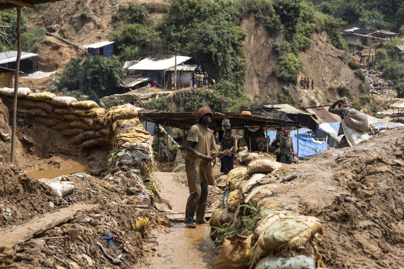 Miners walk Thursday, Sept. 5, 2024 in Kamituga, eastern Congo. (AP Photo/Moses Sawasawa)