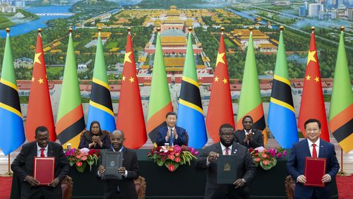 In this photo released by Xinhua News Agency, real from left, Tanzania's President Samia Suluhu Hassan, Chinese President Xi Jinping and Zambia President Hakainde Hichilema applaud as they witness the signing of a memorandum of understanding on the revitalisation project of the Tanzania-Zambia Authority railway, at the Great Hall of the People in Beijing, Wednesday, Sept. 4, 2024, ahead of the China Africa Forum. (Zhai Jianlan/Xinhua via AP)