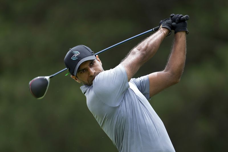 Aaron Rai hits from the fourth tee during the final round of the Rocket Mortgage Classic golf tournament at Detroit Country Club, Sunday, June 30, 2024, in Detroit. (AP Photo/Paul Sancya)