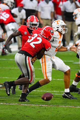 Georgia linebacker Monty Rice (32) strips the ball from Tennessee quarterback Jarrett Guarantano in the pocket during the second half of a football game Saturday, Oct. 10, 2020, at Sanford Stadium in Athens. Georgia won 44-21. JOHN AMIS FOR THE ATLANTA JOURNAL- CONSTITUTION