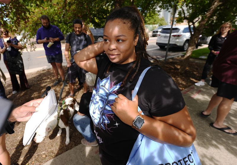 Reya Roussel, who lives next door to the suspect in a shooting spree at an apartment complex, talks to reporters early Thursday, Sept. 12, 2024, in Broomfield, Colo., a Denver suburb. (AP Photo/David Zalubowski)