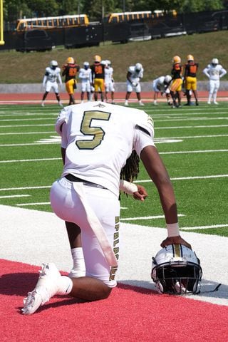 Apalachee #5  Norman Robinson has a moment on the sidelines during the first half as his team falls behind.
Apalachee High School returned to the field against Athens Clarke Central Saturday September 28, 2024 in their first game since the school schooting earlier in the month.

 Nell Carroll for the Journal Constitution