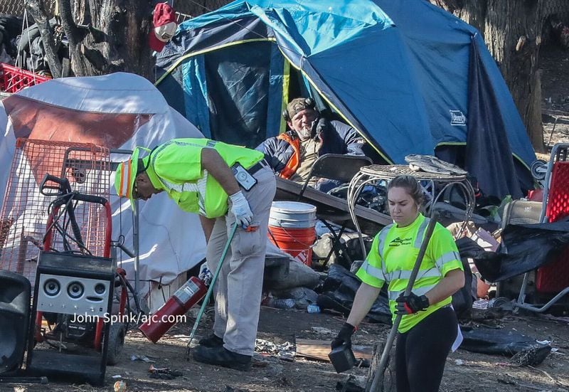 Atlanta Police and GDOT officials clear the site of a homeless encampment Monday.