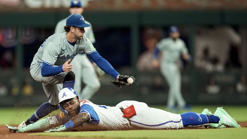 Toronto Blue Jays third baseman Ernie Clement (28) tags Atlanta Braves' Michael Harris II (23) out at second in the fifth inning of a baseball game, Saturday, Sept. 7, 2024, in Atlanta.(AP Photo/Mike Stewart)