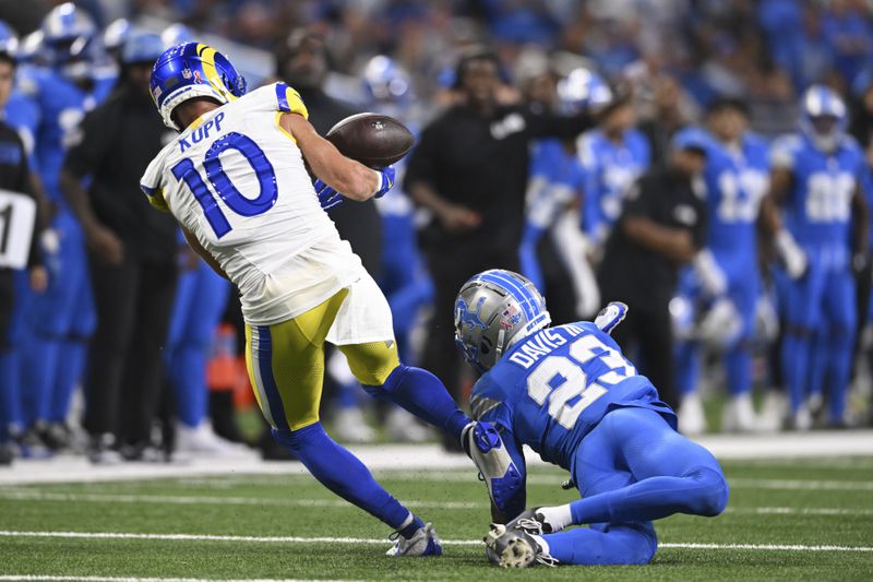 Los Angeles Rams wide receiver Cooper Kupp (10) can't hold onto a pass as Detroit Lions cornerback Carlton Davis III (23) defends during the first half of an NFL football game in Detroit, Sunday, Sept. 8, 2024. (AP Photo/David Dermer)