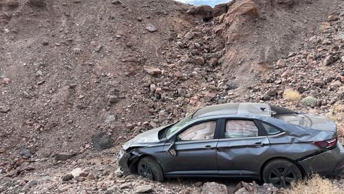 This image provided by the National Park Service shows a car owned by Peter Hayes Robino of Duarte, who drove off a 20-foot embankment at the edge of the parking lot at Death Valley National Park, on Aug. 1, 2024, and died of hyperthermia, or overheating. (National Park Service via AP)