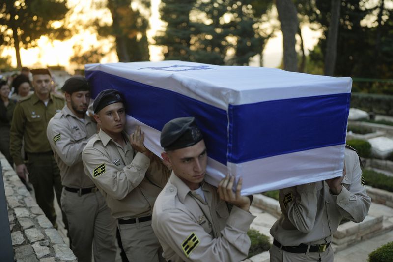 Israeli Navy sailors carry the flag-draped coffin of Petty Officer 1st Class David Moshe Ben Shitrit, who was killed on a Hezbollah attack, during his funeral at the Mount Herzl military cemetery in Jerusalem, Sunday, Aug. 25, 2024. (AP Photo/Ohad Zwigenberg)