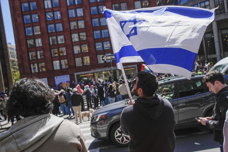 FILE — New York University students and pro-Israeli supporters rally across the street from where Pro-Palestinian students and supporters are rallying outside the NYU Stern School of Business building, April 22, 2024, in New York. (AP Photo/Mary Altaffer, File)