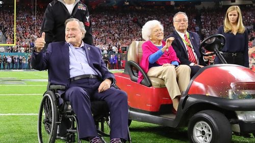 FEBRUARY 5, 2017 HOUSTON TX Former President George H.W. Bush gives the cheering crowd a thumbs up and former First Lady Barbara Bush waves as they take the field for the coin toss while the Atlanta Falcons meet the New England Patriots in Super Bowl LI at NRG Stadium in Houston, TX, Sunday, February 5, 2017. Curtis Compton/AJC