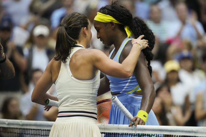 Emma Navarro, left, of the United States, embraces Coco Gauff, of the United States, after defeating her in the fourth round of the U.S. Open tennis championships, Sunday, Sept. 1, in New York. 2024. (AP Photo/Pamela Smith)