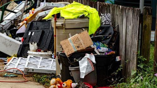 Waste and other materials are often stacked in side yards and near the street at homes with no trash can in Chickasaw, Alabama. (Photo Courtesy of Lee Hedgepeth/Inside Climate News)