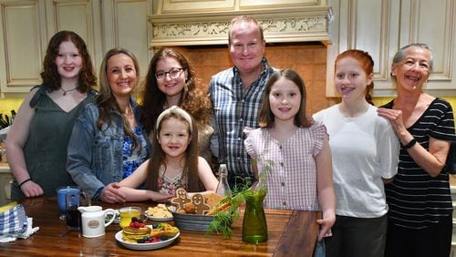 Health concerns in her family helped push Cristina Kisner, a mom of five daughters, toward cooking. She went on to own Cristy’s Kitchen in Roswell. The family includes (from left) Gala Gracey, Kisner, Camila Gracey, Hebe Gracey (in front of Camila), husband Sebastian Gracey, Josefina Gracey, Julieta Gracey and Laura Gylling (Kisner's mother). (Styling by Cristina Kisner / Chris Hunt for the AJC)