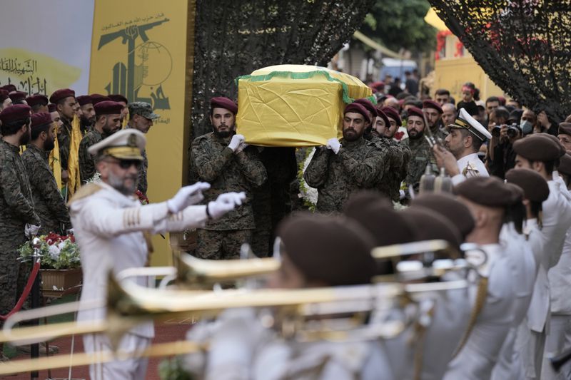 Hezbollah members carry the coffin of Hezbollah commander Ibrahim Akil during the funeral procession in Beirut's southern suburb, Sunday, Sept. 22, 2024. (AP Photo/Bilal Hussein)