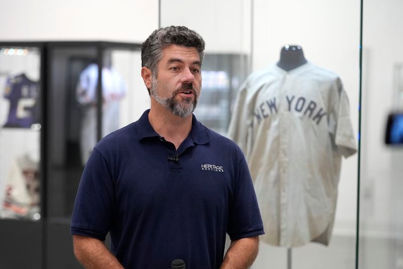 Mike Provenzale, Production manager at Heritage Auctions, talks about the 1932 Babe Ruth game worn New York Yankees World Series "Called Shot" jersey on display at Heritage Auctions in Irving, Texas, Wednesday, Aug. 21, 2024. (AP Photo/LM Otero)