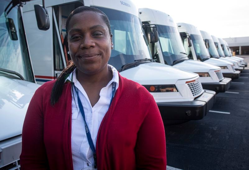 U.S. Postal Service delivery driver Avis Stonum stands in the work lot of a postal facility on Thursday, Sept. 5, 2024, in Athens, Ga. (AP Photo/Ron Harris)