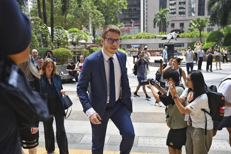 Foreign diplomats arrive at the district court ahead of the verdict on Chung Pui-kuen, the ex-chief editor of the now shuttered Stand News online outlet and his colleague Patrick Lam, former acting chief editor, in Hong Kong on Thursday, Aug. 29, 2024. (AP Photo/Billy H.C. Kwok)