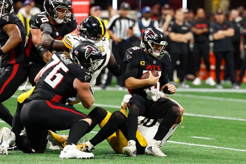 Pittsburgh Steelers linebacker T.J. Watt (90) sacks Atlanta Falcons quarterback Kirk Cousins (18) during the second half of an NFL football game Sunday, Sept. 8, 2024, in Atlanta. (AP Photo/Butch Dill)