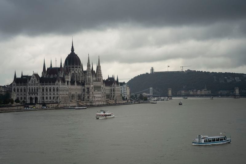 Dark clouds are seen over the Parliament building in Budapest, Hungary, during the flooding of the Danube river on Monday, Sept. 16, 2024. (AP Photo/Denes Erdos)