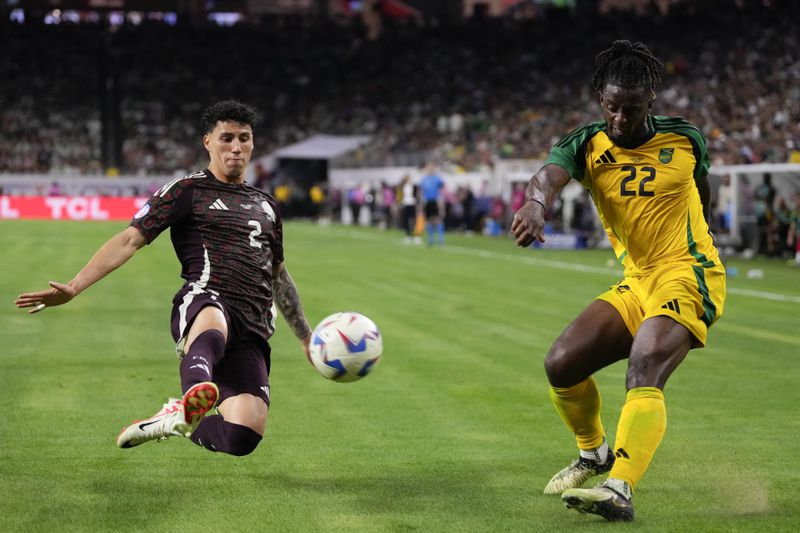 Mexico's Jorge Sanchez, left, tries block a shot by Jamaica's Greg Leigh during a Copa America Group B soccer match in Houston, Saturday, June 22, 2024. (AP Photo/Kevin M. Cox)