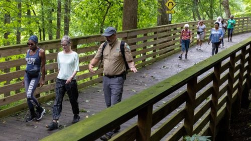 Members of a walking group walk on a trail at Mason Mill park in Decatur on Wednesday, July 31, 2024. (Arvin Temkar / AJC)