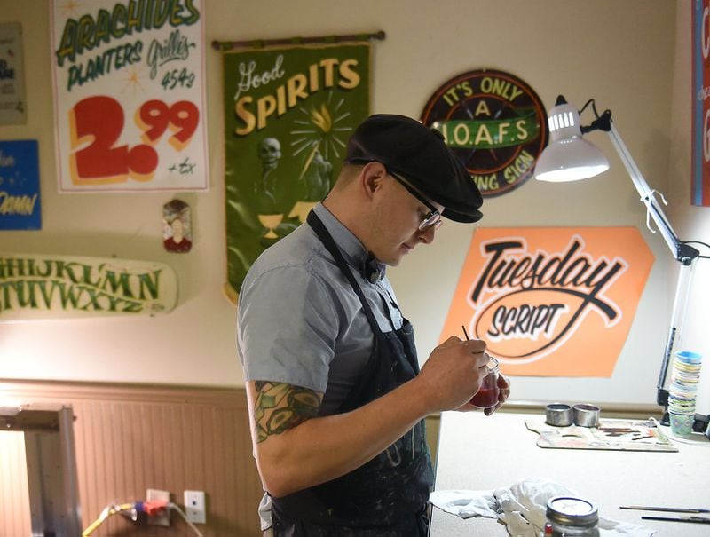 Chris Sturdivant prepares to create another hand painted sign in his is Atlanta studio. RYON HORNE / RHORNE@AJC.COM