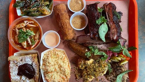 This sampling from Gene's includes (clockwise from top left) smashed cucumber salad, boudin egg roll with spicy mustard, ribs, brisket, pulled pork, chili-brined chicken skewers, jalapeño slaw, tart cherry bread pudding and marinated crab claws. (Ligaya Figueras/lfigueras@ajc.com)