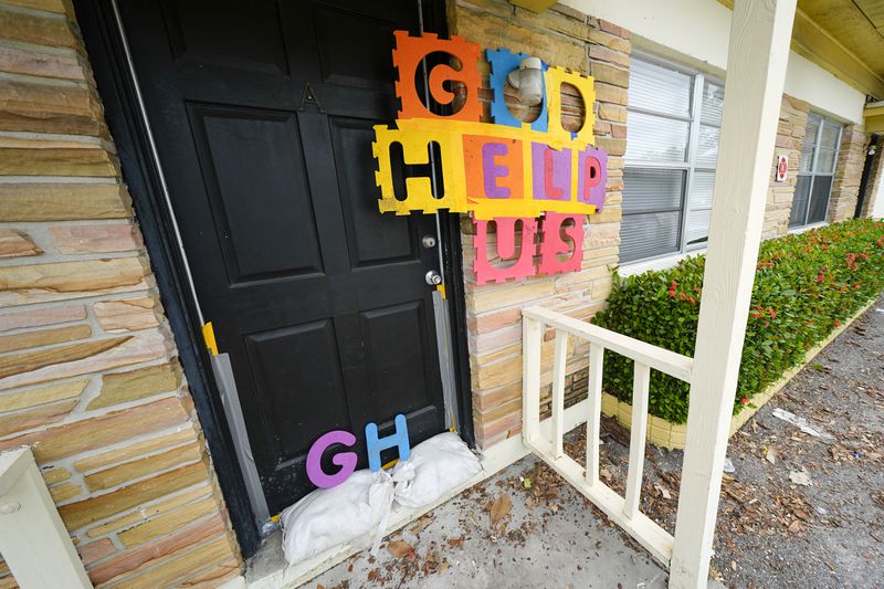 A message is seen outside of an apartment in the Davis Islands community of Tampa, Fla., as residents prepare for the arrival of Hurricane Milton, Tuesday, Oct. 8, 2024. (AP Photo/Julio Cortez)