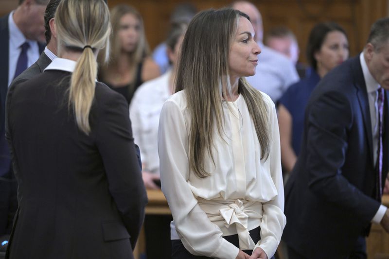 Karen Read, center, stands amid her lawyers during a break in proceedings during Read's trial in Norfolk Superior Court, Friday, June 21, 2024, in Dedham, Mass. Read, 44, is accused of running into her Boston police officer boyfriend with her SUV in the middle of a nor'easter and leaving him for dead after a night of heavy drinking. (AP Photo/Josh Reynolds, Pool)