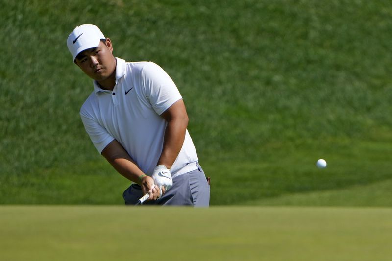 Tom Kim, of South Korea, chips up on the 15th hole during the first round of the Travelers Championship golf tournament at TPC River Highlands, Thursday, June 20, 2024, in Cromwell, Conn. (AP Photo/Seth Wenig)