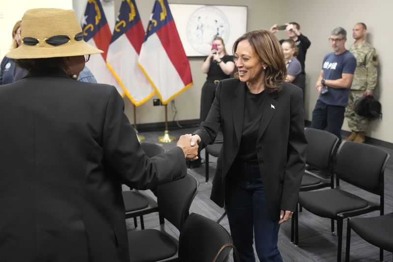 Democratic presidential nominee Vice President Kamala Harris, right, greets local officials after receiving a briefing on the damage from Hurricane Helene, Saturday, October 5, 2024 in Charlotte, N.C. (AP Photo/Chris Carlson)